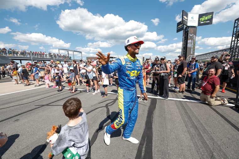 Lavar Scott waves to a young fan before the start of NASCAR's O'Reilly Auto Parts series at Pocono Raceway on Saturday.