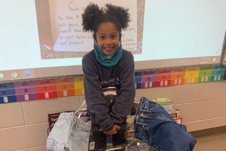 Kamryn Gardner in her first-grade classroom last month at Evening Star Elementary in Bentonville, Ark., with the Old Navy pants and shorts (with pockets) the company sent her after receiving her letter.