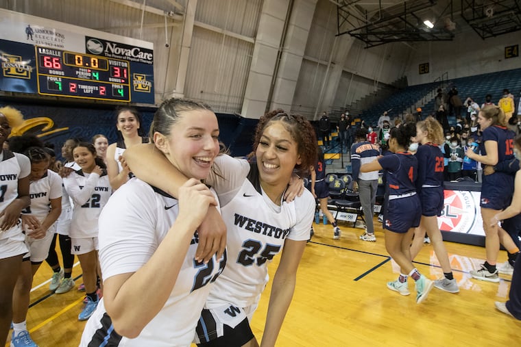 Westtown School's Grace Sundback (left) celebrates winning the Friends Schools League basketball championship with Kaylene Smikle.