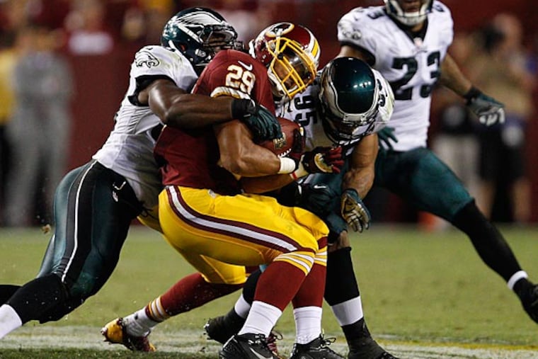 Eagles linebackers DeMeco Ryans and Mychal Kendricks sandwich the Redskins' Roy Helu Jr. (David Maialetti/Staff Photographer)