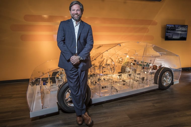 Terrence Curtin, TE Connectivity chief executive, with a transparent car, showing all the connectors TE Connectivity manufactures.