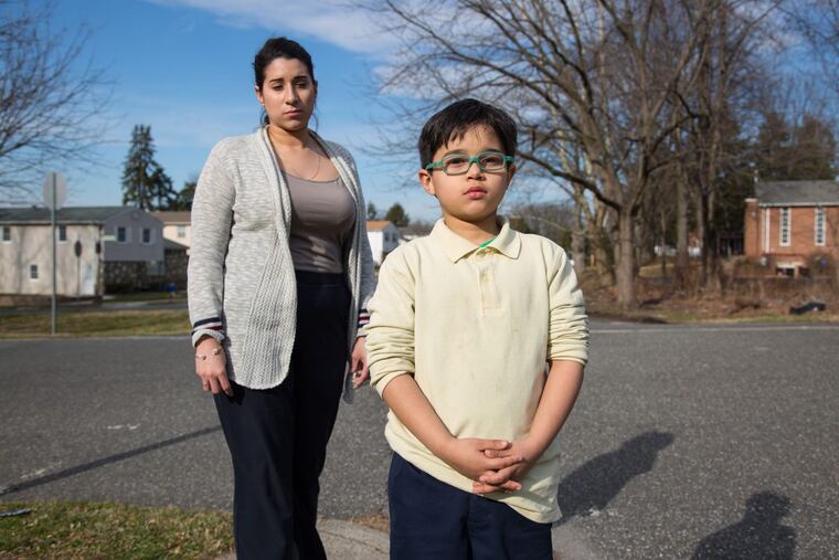 Cristine Gonzalez, left, and her six-year-old son Dean Pagan, right, shown here as Cristine picks up Dean from the school bus stop, in Philadelphia, Monday, February 26, 2018. Dean was severely lead poisoned at Comly Elementary School.