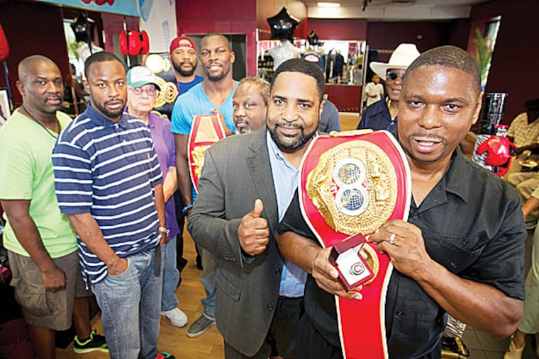 Charles 'The Hatchet' Brewer receives his championship ring from Daryl Peoples, IBF president. (Alejandro A. Alvarez/Staff Photographer)