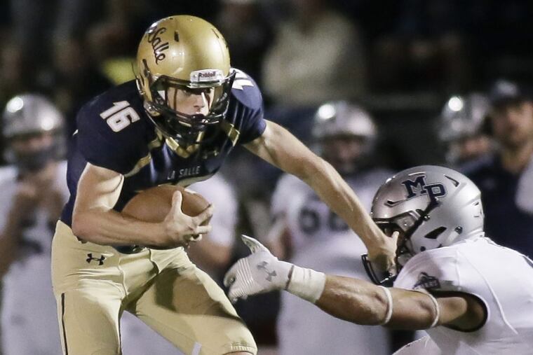 La Salle quarterback Danny Solecki tries to avoid Malvern Prep's Keith Maguire.