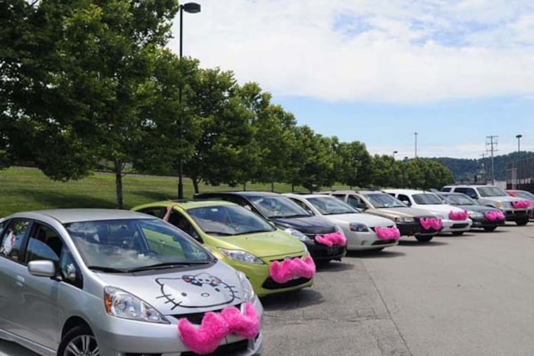 Lyft cars, with their trademark pink mustaches, ready for a parade in Western Pennsylvania. (Connor Mulvaney/Pittsburgh Post-Gazette/TNS)