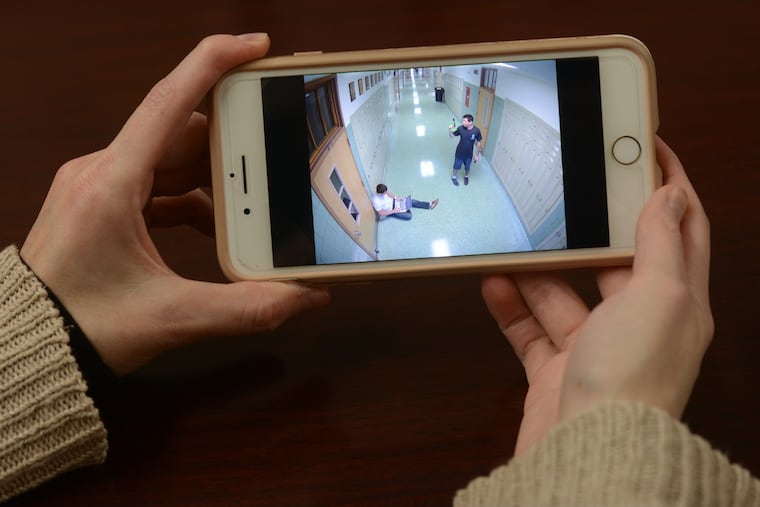 Archbishop Wood High School Director of Marketing and Communications Lisa James shows video on her phone from a test run of the newly installed technology that allows security cameras that detect someone with a weapon to immediately send text alerts to staff and police.