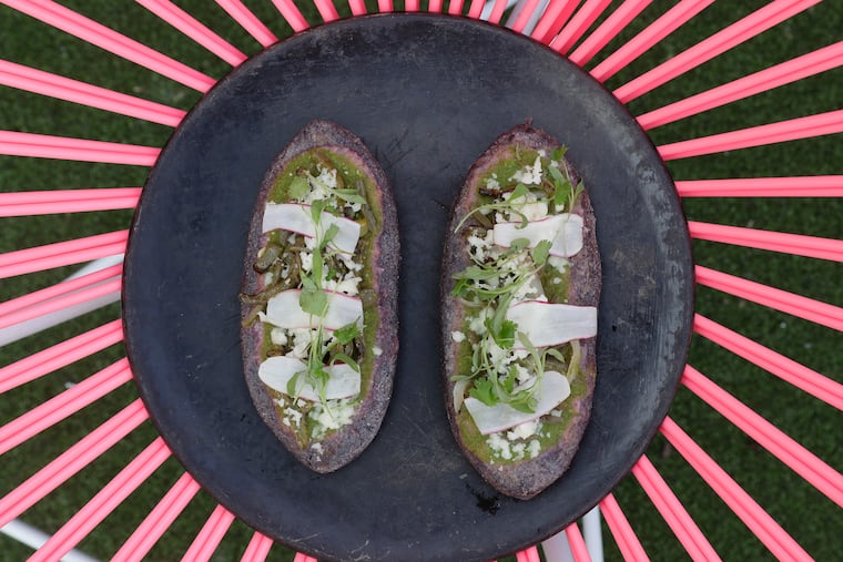 The tlacoyos, grilled corn masa cakes filled with black beans, nopales, salsa verde and queso fresco from Sor Ynéz.