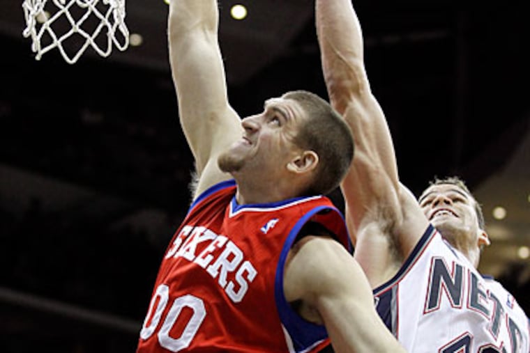 Spencer Hawes scored 19 points off the bench in the Sixers' rout of the Nets. (Julio Cortez/AP)