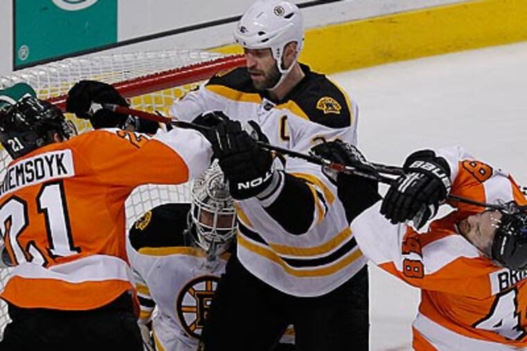 Danny Briere took a whack on the side of the head from Zdeno Chara's stick in Game 1. (Ron Cortes/Staff Photographer)