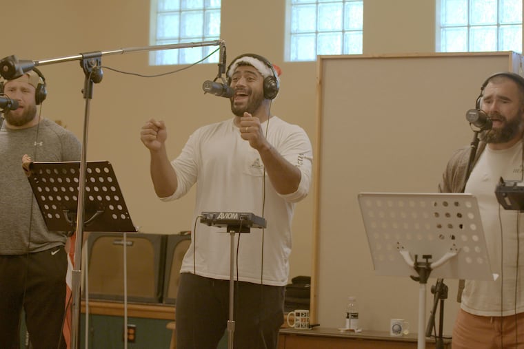 Philadelphia Eagles linemen Jason Kelce, Jordan Mailata, and Lane Johnson in the studio recording "A Philly Special Christmas Special," the trio's new album of holiday song to benefit Philadelphia charities which will be released in November.