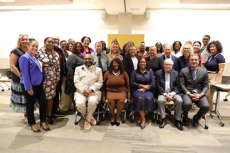 Camden school Superintendent Katrina McCombs (seated, third from left) and Rowan University officials kicked off the Teach Camden program for 19 paraprofessionals hoping to become certified teachers.