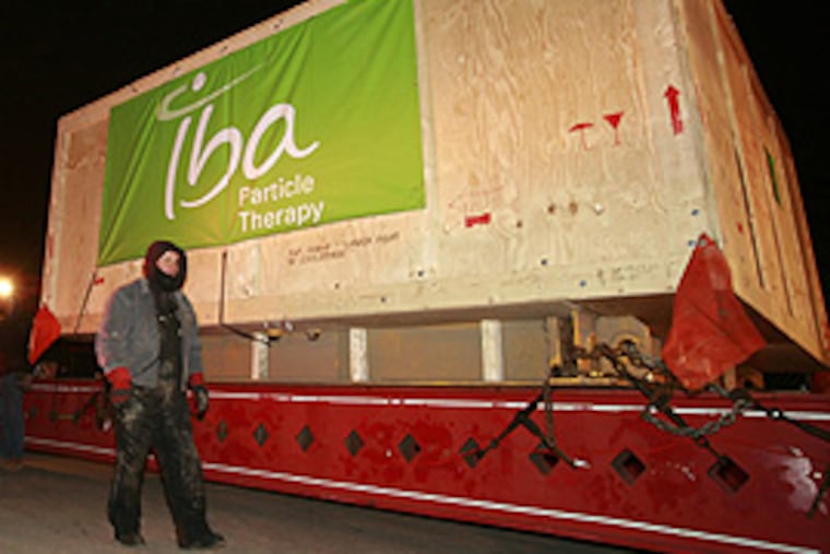 A 200-foot-long, 20-axle truck delivered a giant particle accelerator for Penn this morning for the world's largest proton therapy center. (Mike Levin/Inquirer)