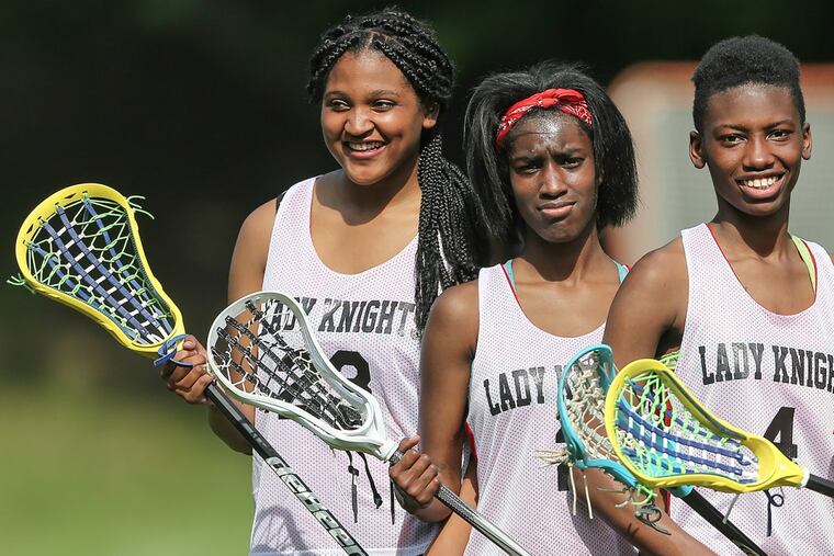 Strawberry Mansion’s lacrosse players, including Nadirah McRae, far right, when they were playing lacrosse their first season. Now, McRae is suing the school district.