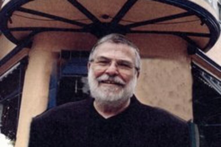 Eugene H. Gosfield in front of Under the Blue Moon, his Chestnut Hill restaurant, in an undated family photograph.