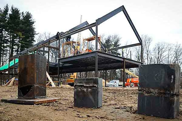 Sections of steel beams that were cut with a torch sit in front of the Quaker meeting house construction site in Chestnut Hill in January 2013. (RON TARVER / Staff Photographer )