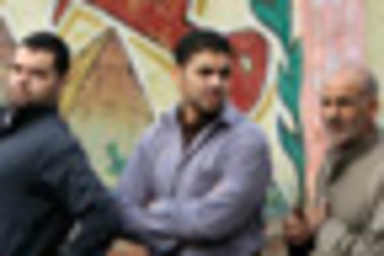 Egyptians line outside a polling station in front of a graffiti showing the Pyramids and Arabic word Egypt, in Giza, Egypt, Wednesday, Dec. 14, 2011. Egypt held Wednesday the second round of parliamentary voting, part of the first elections since President Hosni Mubarak was ousted in February. (AP Photo/Amr Nabil)