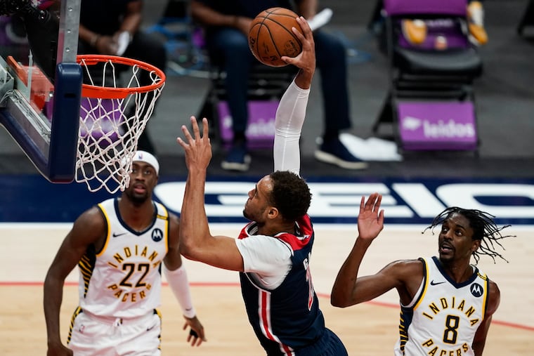 Wizards forward Daniel Gafford (center) dunks the ball in front of Indiana's Caris LeVert (left) and Justin Holiday.