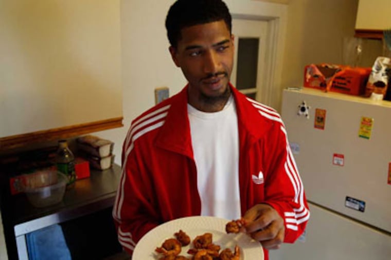 Bardre Parrish samples his fried shrimp his kitchen in Philadelphia on
November 12, 2012. ( DAVID MAIALETTI / Staff Photographer )