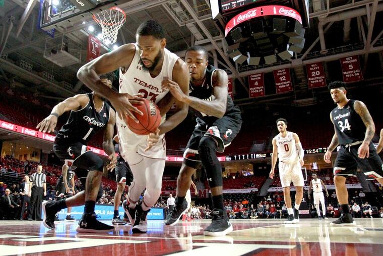 Damion Moore, center, of Temple and Gary Clark, 3rd from left, of Cincinnati battle for a loose ball during the 1st half of the game at the Liacouras Center at Temple University on Jan 4, 2018.