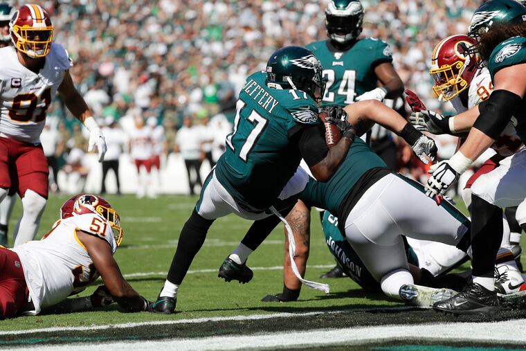 Eagles wide receiver Alshon Jeffery scores on a two-yard run Sunday in the Eagles' 32-27 win over Washington. Jeffery also caught a five-yard touchdown pass.