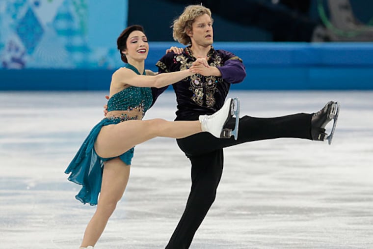 Meryl Davis and Charlie White of the United States compete in the team free ice dance figure skating competition at the Iceberg Skating Palace during 2014 Winter Olympics, Sunday, Feb. 9, 2014, in Sochi, Russia. (Ivan Sekretarev/AP)