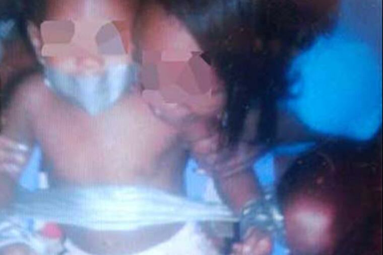 A mother is arrested after pictures emerged of her baby duct-taped to
his high chair. Police say the photo came emerged when the mom went in
to Chester police to complain about identity theft.