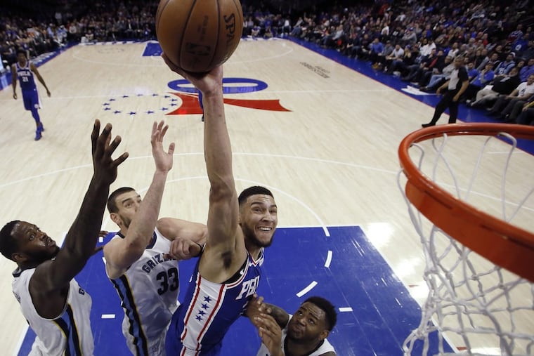The Sixers’ Ben Simmons, goes up for a shot against the Memphis Grizzlies’ JaMychal Green, Marc Gasol and Jarell Martin, from left, during the first half Wednesday night.