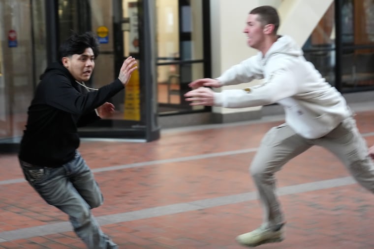 Plain clothed federal agents pursue a man through the lobby of the Hennepin County Government Center in Minneapolis before tackling and arresting him, on Tuesday, Feb. 10, 2026.