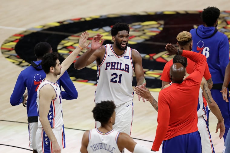 Sixers center Joel Embiid celebrates with his teammates after they beat the Hawks in Atlanta Friday night to force a Game 7 in their Eastern Conference Semifinal playoff series.