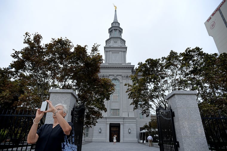 Church member Bobbie Konover of Dresher, PA takes photos outside the Church of Jesus Christ of Latter-day Saints on Logan Square August 1, 2016. The new Temple will be dedicated in September.