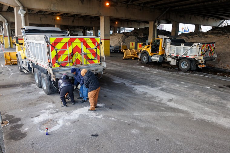 PennDot workers at Oregon Avenue and South Swanson Street in South Philadelphia get equipment ready.