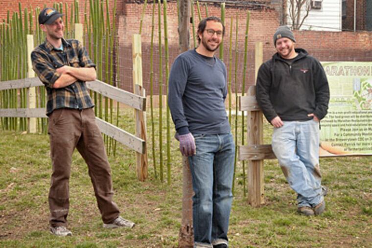 Urban-farm promoter Patrick Dunn (from left), with Marathon Restaurants CEO Cary Borish and farm director Adam Hill. (Maria Pouchnikova / Staff Photographer)