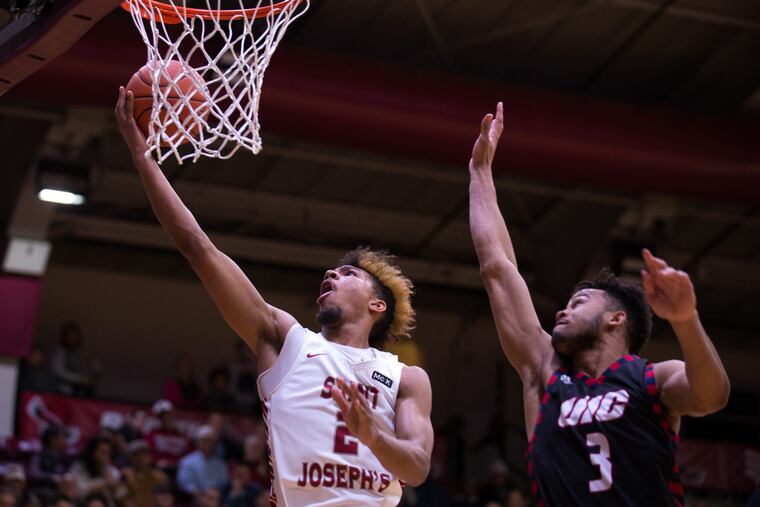 St. Joseph forward Charlie Brown, #2, scores against UIC's Jacob Wiley, #3, at St. Joseph's University on Wednesday, November 28, 2018. KRISTON JAE BETHEL / For the Inquirer