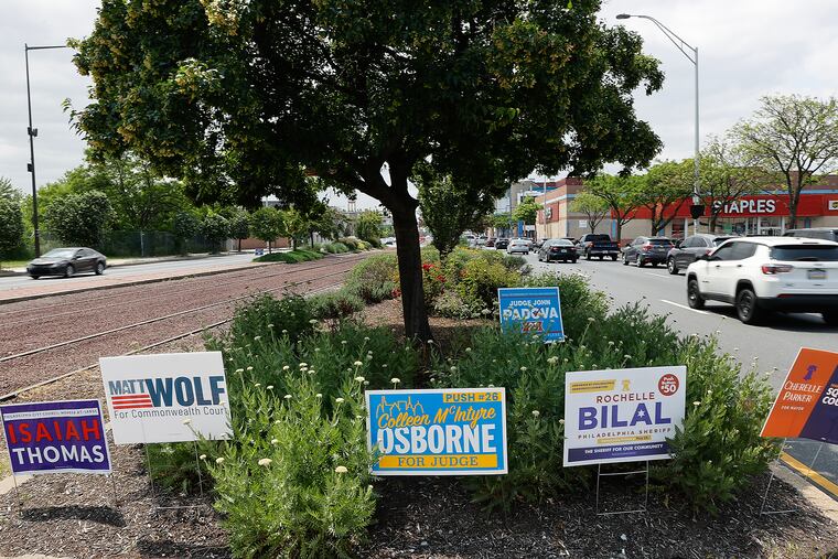 Campaign signs sit in a traffic island on South Columbus Boulevard near Washington Avenue in South Philadelphia on Sunday.