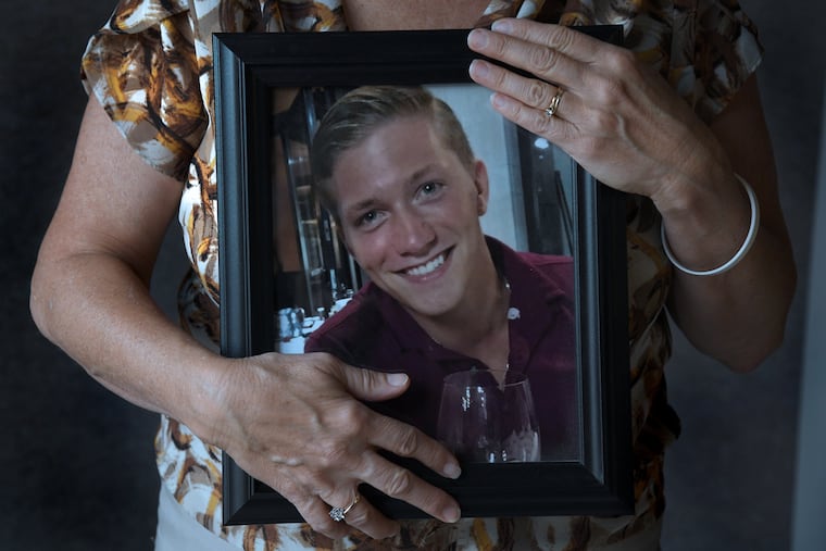 Angela Smith holds a portrait of her late son Pete, who died last year after the bacteria that cause Lyme disease spread to his heart.