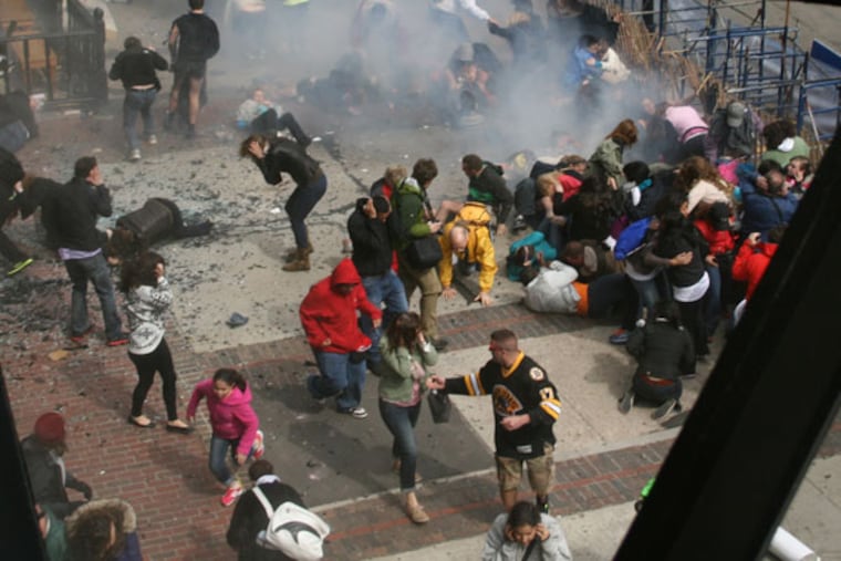 This Monday April 15, 2013 photo provided by Ben Thorndike shows the scene following an explosion at the 2013 Boston Marathon in Boston. Two explosions shattered the euphoria of the Boston Marathon finish line on Monday, sending authorities out on the course to carry off the injured while the stragglers were rerouted away from the smoking site of the blasts. (AP Photo/Ben Thorndike)