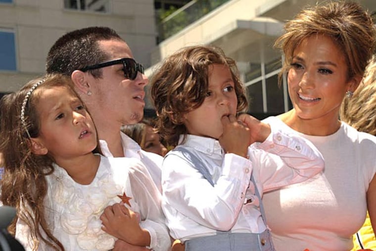 Jennifer Lopez (right) with Beau "Casper" Smart, holding her two children, Emme Muniz (left) and Maximilian Muniz. (JOHN SHEARER / AP)