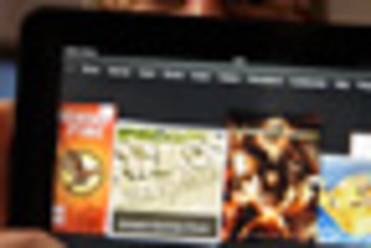 Amazon Kindle vice president Peter Larsen holds the Kindle Fire HD at the introduction of the new Kindle devices in Santa Monica, Calif., Thursday, Sept. 6, 2012. (AP Photo/Reed Saxon)