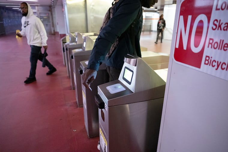 SEPTA riders using their credit cards to pay at the SEPTA city hall station on Friday, Sept. 29, 2023.