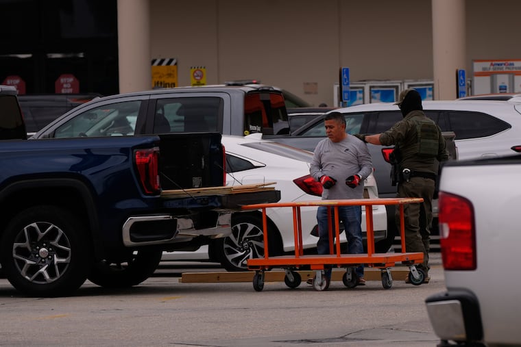 U.S. Customs and Border Protection agents question a person at a Home Depot parking lot in Kenner, La., on Wednesday, Dec. 3, 2025.