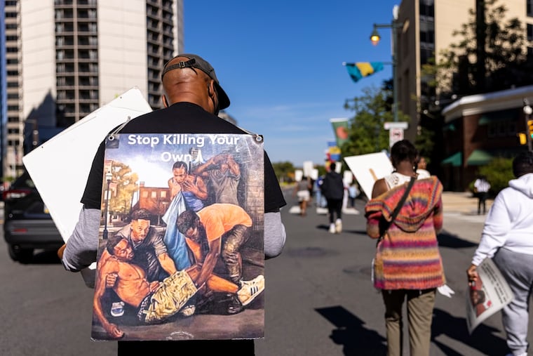 A handful of people gather and march to the Art Museum for the Million Moms March to commemorate victims of gun violence in Philadelphia, Pa., on Saturday, Sept. 11, 2021.
