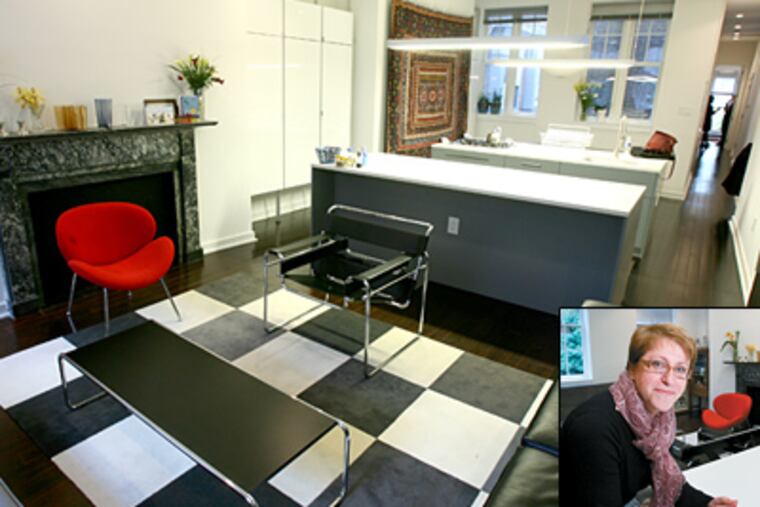 The living room of Franca Trubiano's (inset) condo looking towards the open kitchen. (Charles Fox / Staff Photographer)