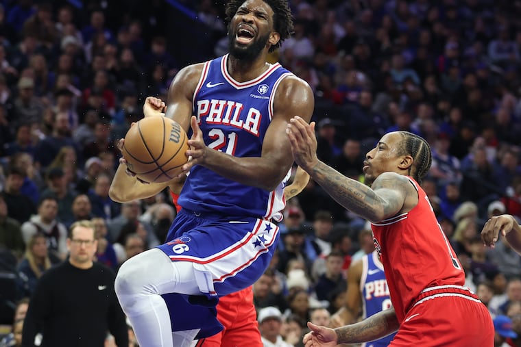 Joel Embiid of the Sixers gets fouled by DeMar DeRozan of the Bulls during the second half Tuesday at the Wells Fargo Center.