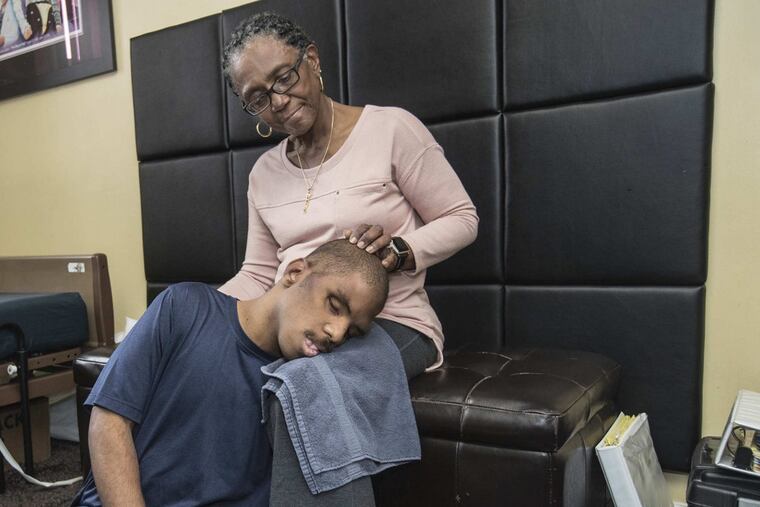 Annette Scott strokes her son Justin’s head while laying his head on her lap.