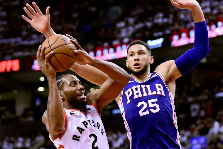 Kawhi Leonard (2) looks for the shot as Philadelphia 76ers guard Ben Simmons (25) defends during the second half of Game 1 of a second-round NBA basketball playoff series, in Toronto, Saturday, April 27, 2019.