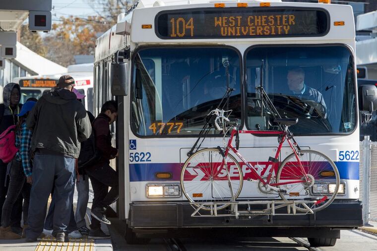 Commuters load a bus for the West Chester University at the 69th Street terminal.