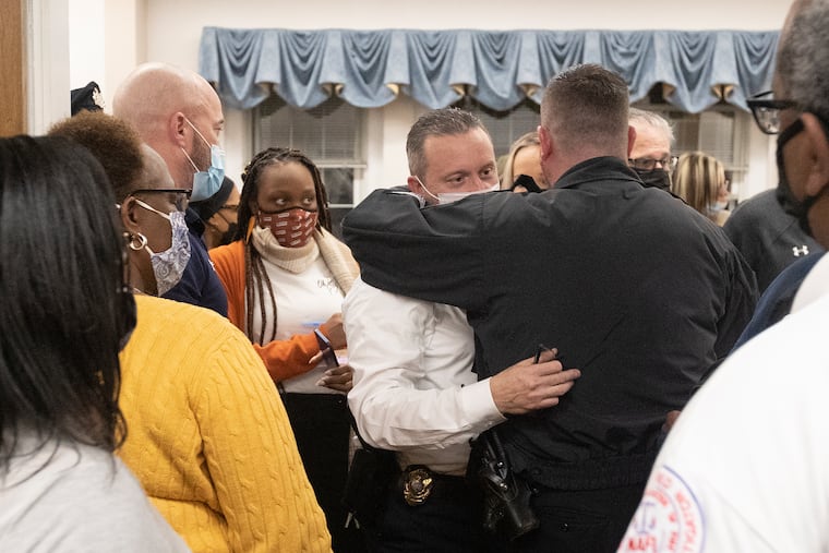 Yeadon Police Chief Anthony Paparo hugs a police officer as he leaves Yeadon Borough Council Chambers. The council voted 4-3 Thursday night to fire Paparo.