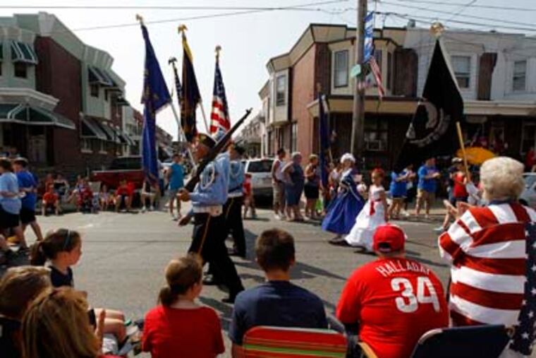 People watch veterans march past during a Memorial Day parade Monday, May 30, 2011, in the Bridesburg neighborhood of Philadelphia. (AP Photo/Matt Rourke)