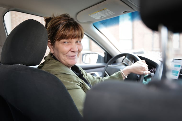 Patrice Davis, a Uber driver, poses in her car in Philadelphia, PA on April 9, 2019.