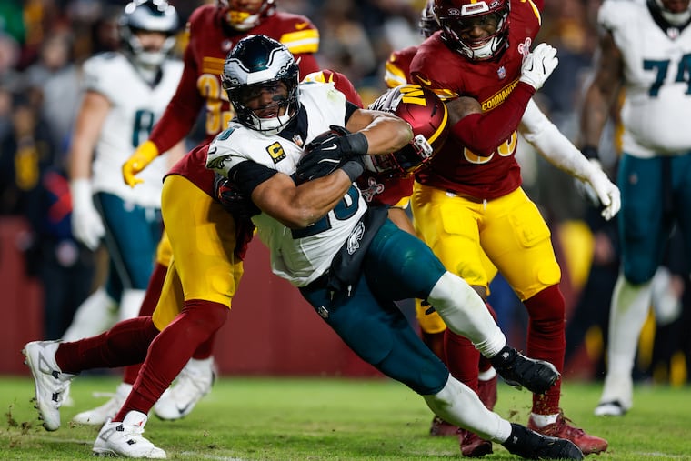 Eagles running back Saquon Barkley runs past Commanders linebacker Bobby Wagner for a fourth quarter touchdown Saturday, Dec. 20, 2025, in Landover, Md.